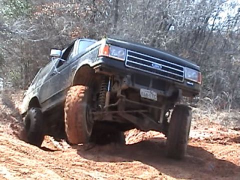 1991 Ford Bronco - This lifted 1991 Ford Bronco navigates a challenging off-road course with its front wheel high in the air.