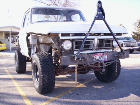 1978 Ford Bronco - This pickup truck has a custom front end and tow bar, with another truck visible in the background.