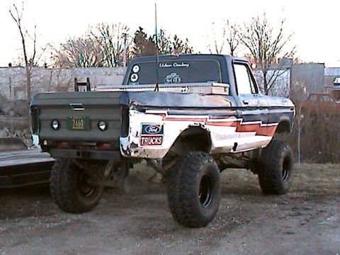 1977 Ford F-150 - This lifted Ford pickup truck features a custom paint job and a toolbox mounted on the bed.