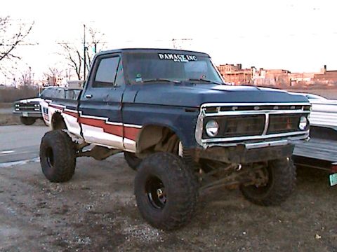 1977 Ford F-150 - A lifted pickup truck with a custom paint job is parked outdoors next to another vehicle.