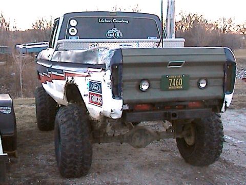 1977 Ford F-150 - Rear view of a modified 1977 Ford F-150 pickup truck with custom bed and off-road tires.