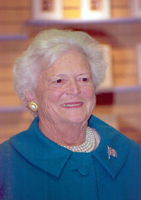 1991 Ford Bronco - Barbara Bush smiles, adorned with pearls and an American flag pin on her teal coat.