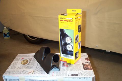 1998 Ford Crown Victoria - Unboxed Auto Meter Dual Gauge Pod and a separate gauge pod are displayed, with a covered vehicle behind.