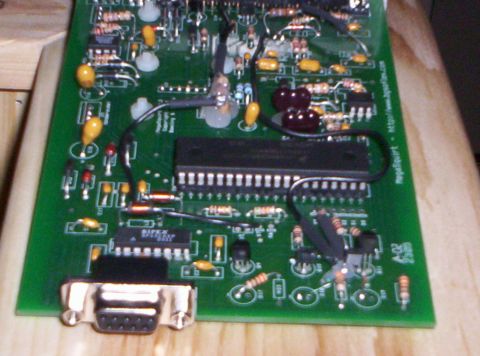 1993 Ford Probe - Close-up view of a green circuit board various electronic components and a DB9 serial port connector.