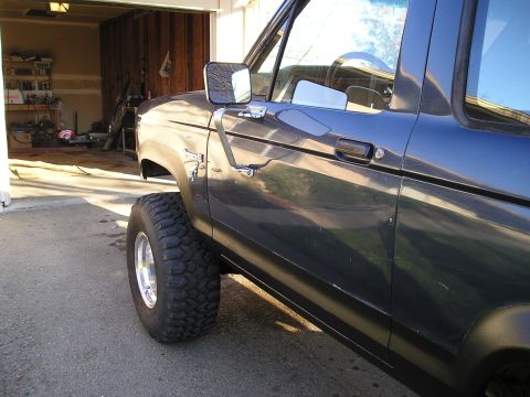 1986 Ford Bronco II - This 1986 Ford Bronco II is parked outside a garage, its lifted suspension and off-road tires.