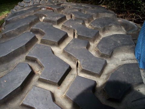1991 Ford Bronco - Aggressive tire tread pattern shown in close-up. Supermotors.net logo is visible.