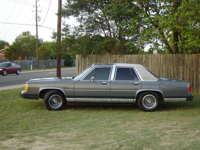 Gray 1988 Ford Crown Victoria LTD parked on grass, side view