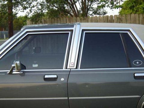 1988 Ford LTD Crown Victoria - This 1988 Ford Crown Victoria LTD features distinctive chrome trim around the windows and a dark gray exterior.