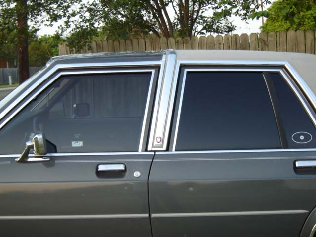 Side view of 1988 Ford Crown Victoria LTD showing chrome trim and tinted windows