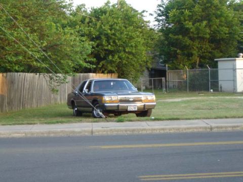 1988 Ford LTD Crown Victoria - 1988 Ford Crown Victoria LTD parked on grass, showing its front 3/4 view.