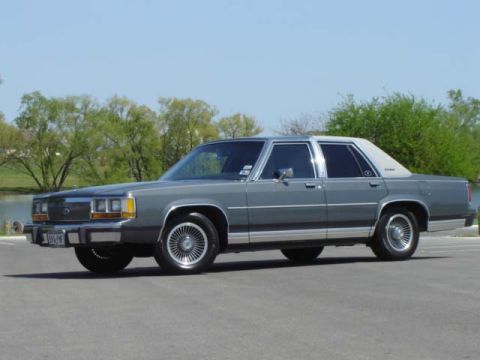 1988 Ford LTD Crown Victoria - This 1988 Ford Crown Victoria LTD sedan is captured in a three-quarter front view, its classic design.