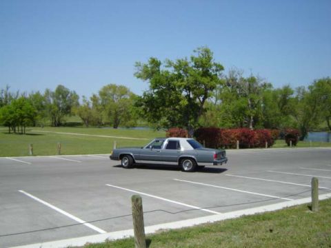 1988 Ford LTD Crown Victoria - A 1988 Ford Crown Victoria LTD is parked in a lot on a clear day.