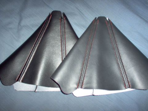 1994 Ford Probe - Two black leather shift boot covers with red stitching are shown against a blue background.