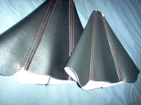 1994 Ford Probe - Two black shift boots with red stitching are shown against a blue background. The "SUPERMOTORS.NET" watermark is visible in the lower right…