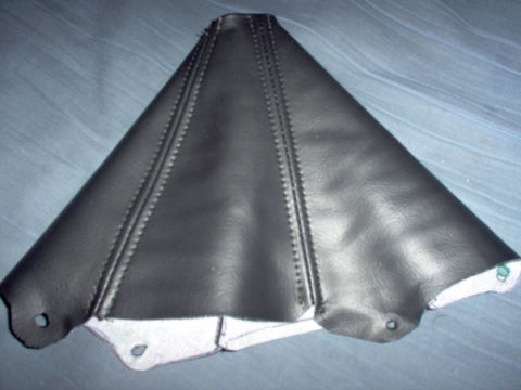 1994 Ford Probe - A black leather gear shift boot with visible stitching and mounting holes is shown against a blue fabric background.