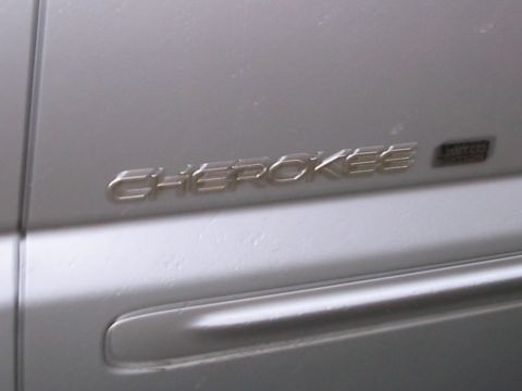 1992 Ford Bronco - Close-up of the 'Cherokee' badge on the side of a silver vehicle.