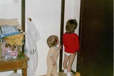 1985 Ford Bronco - Children are seen standing in a room, with one child wearing a red shirt and the other in a light-colored outfit.