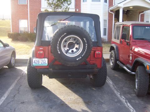 1998 Jeep TJ - Two red Jeep Wranglers parked side-by-side in a parking lot.