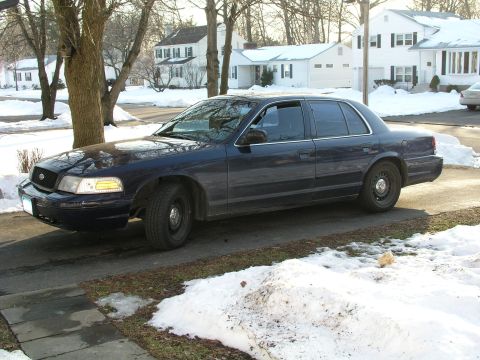 1999 Ford Crown Victoria - A dark blue 1998 Ford Crown Victoria sedan is parked in a driveway during winter.