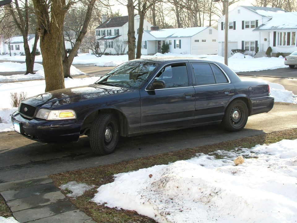 Dark blue 1998 Ford Crown Victoria sedan parked in a snowy driveway