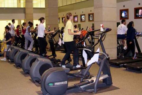 1985 Ford Bronco - People exercise on various machines in a gym, including treadmills and ellipticals.