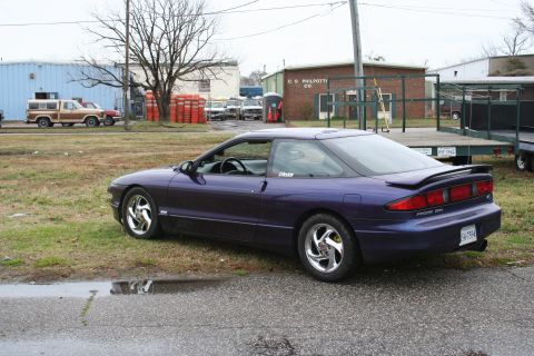 1996 Ford Probe - This 1996 Ford Probe is seen from the rear 3/4 angle, with its distinctive taillights and "PROBE 24V" badging clearly visible.