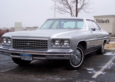 1972 Ford Ranchero - Silver 1973 Chevrolet Caprice sedan parked in a lot with Dillard's sign visible.