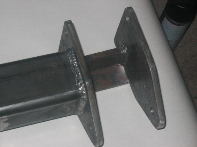 Close-up of a welded steel bracket with two mounting plates