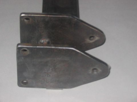 1991 Ford Bronco - Close-up view of two metal brackets, possibly for automotive use.