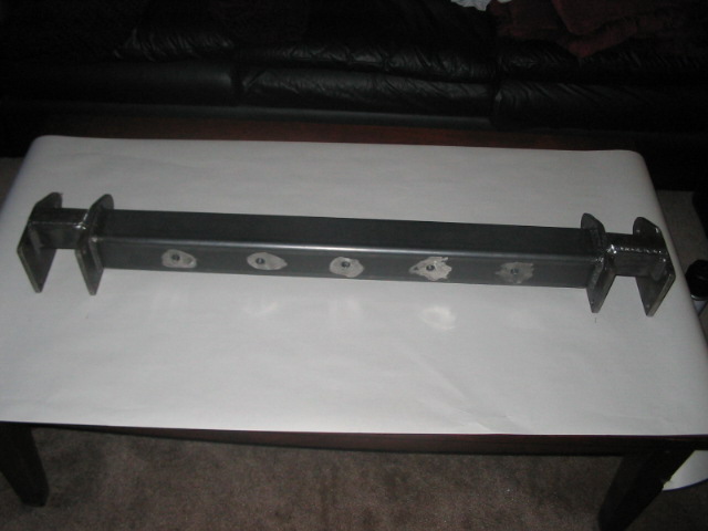 Metal suspension component with six circular cutouts and bracketed ends