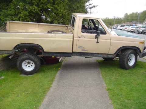 1985 Ford F-150 - This pickup truck, likely from the early 1980s, is shown from the side with a two-tone paint scheme.