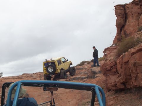 1991 Ford Bronco - Off-roading adventure in a rocky desert landscape with multiple vehicles.
