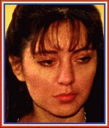 1985 Ford Bronco - A portrait captures a woman's thoughtful expression, with her hair styled in bangs.