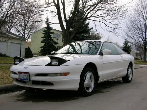 1997 Ford Probe - A white 1997 Ford Probe is seen from a three-quarter front view, parked on a suburban street.