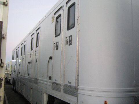 1968 Ford Mustang - A line of portable restrooms is visible, suggesting a temporary event setup.