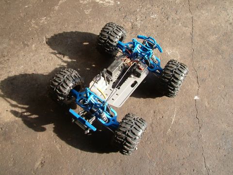 1994 Ford Bronco - Remote control monster truck chassis with blue suspension components and large tires.