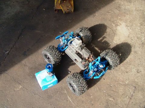 1994 Ford Bronco - Remote control monster truck chassis and engine on a concrete surface.