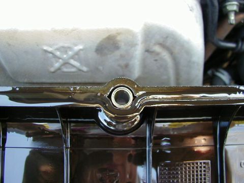 1994 Ford Probe - Close-up of an engine component, possibly an oil pan, showing a circular opening and some oil residue.