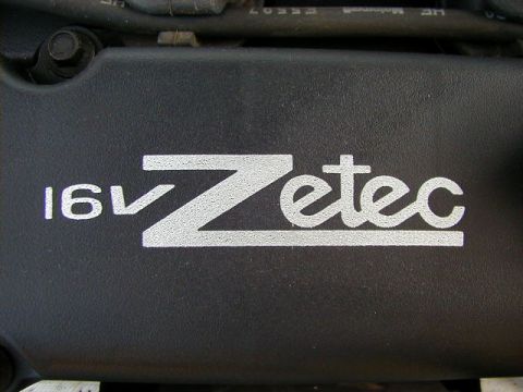 1994 Ford Probe - Close-up of a black engine cover displaying '16V Zetec' in white lettering.