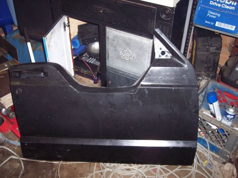 1993 Jeep Cherokee - A detached vehicle door is shown in a cluttered garage setting with various items stored inside its frame.