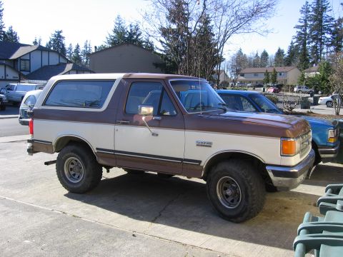 1987 Ford Bronco - Side view of a 1987 Ford Bronco XLT with aftermarket wheels and tires.
