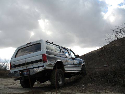 1994 Ford C-350 (Centurion Conversions) - This 1994 Ford C-350 (Centurion Conversions) is seen in a rural, off-road setting under a cloudy sky.