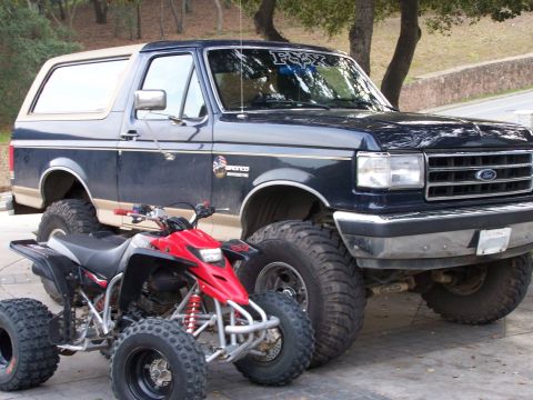 1991 Ford Bronco - This 1991 Ford Bronco is parked next to a red ATV.