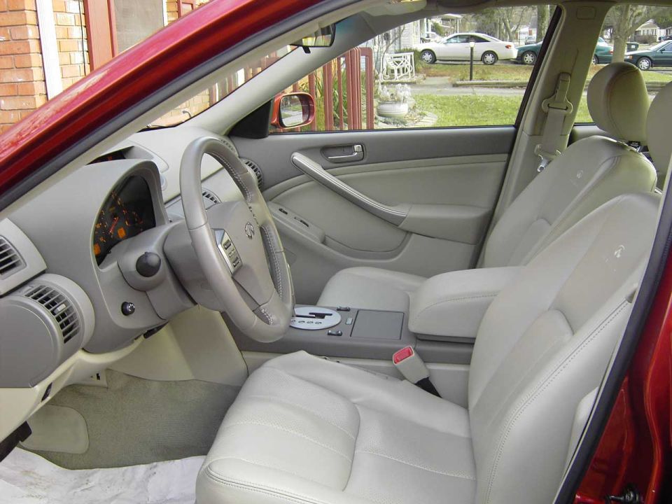 2004 Infiniti G35 interior with light gray leather seats, dashboard, and steering wheel