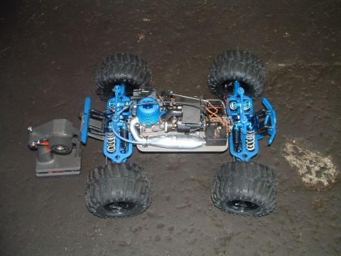 1994 Ford Bronco - This nitro-powered remote control monster truck is shown from a top-down perspective with its chassis and engine exposed.