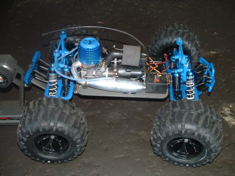 1994 Ford Bronco - This remote control monster truck features a prominent blue engine and tires, suggesting off-road capabilities.