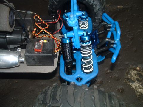 1994 Ford Bronco - Close-up view of the suspension and electronics of a blue remote control car.