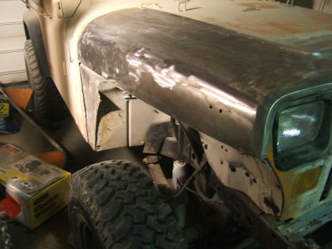 1989 Jeep YJ - Front fender of a 1989 Jeep YJ undergoing bodywork and repair.