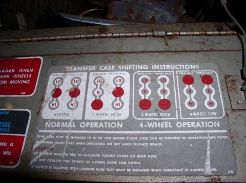 1967 International Scout 800 - This label details the proper operation of a vehicle's transfer case, including warnings about engaging axles and operating on dry surfaces.