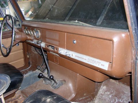 1967 International Scout 800 - The interior of a 1967 International Scout 800 shows its dashboard with gauges and gear shifters.